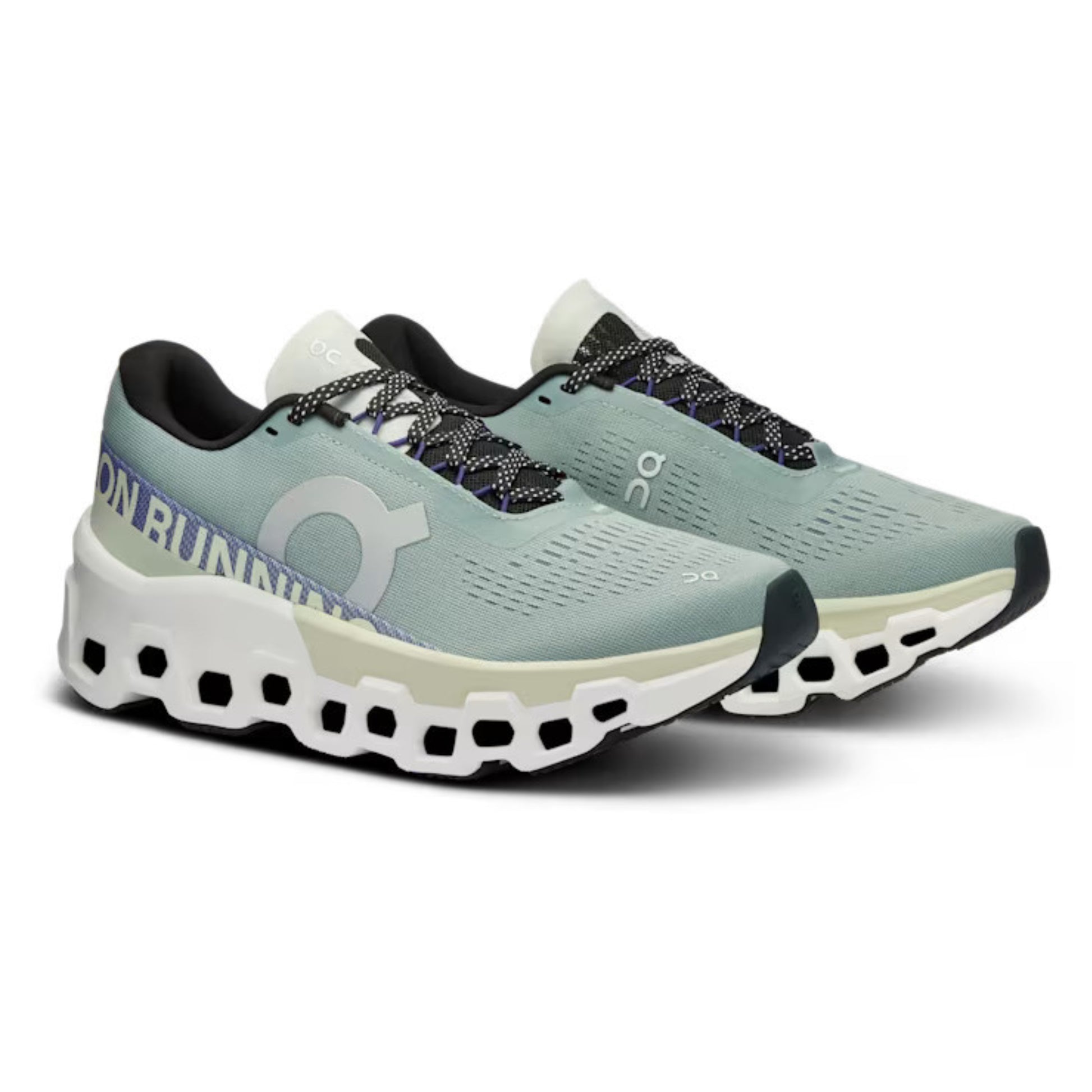 Pair of green ON running shoes on a white background