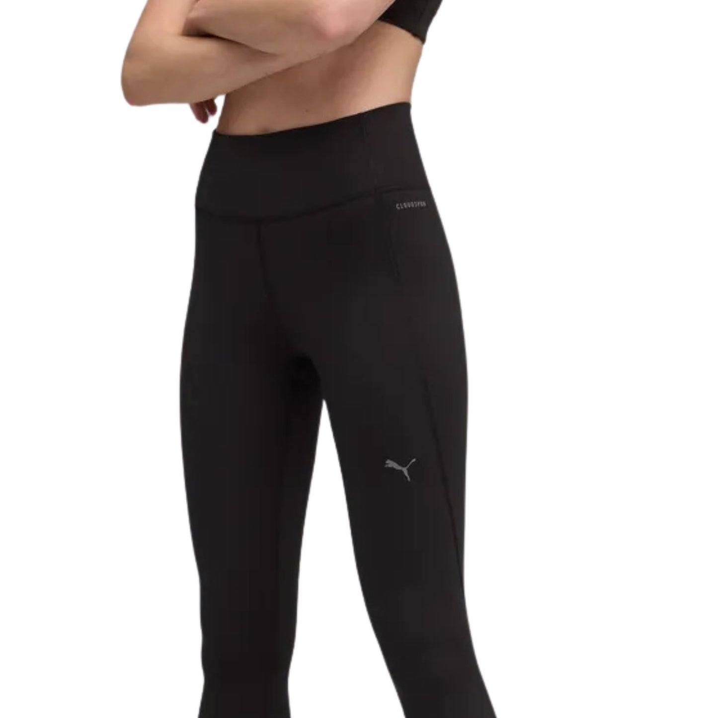 Close-up of a woman wearing a black tight Puma pant on a white background