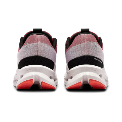 Back view of a pair of running shoes with red accents on a white background