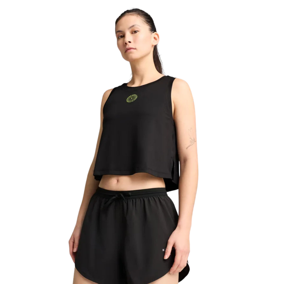 Woman wearing a black sleeveless top and black shorts on a white background