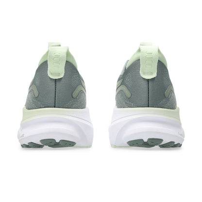 Gray and green running shoes on a white background