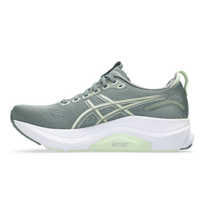 Gray and white running shoe with green accents on a white background