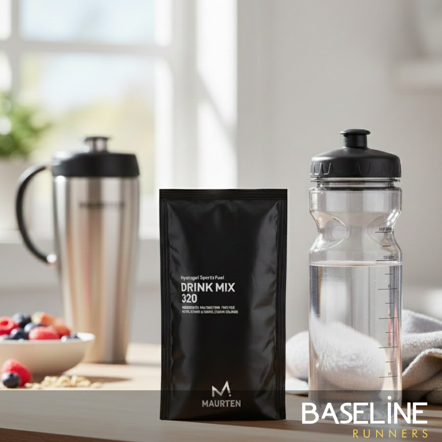 Maurten drink mix packet and clear water bottle on a table with a blurred background