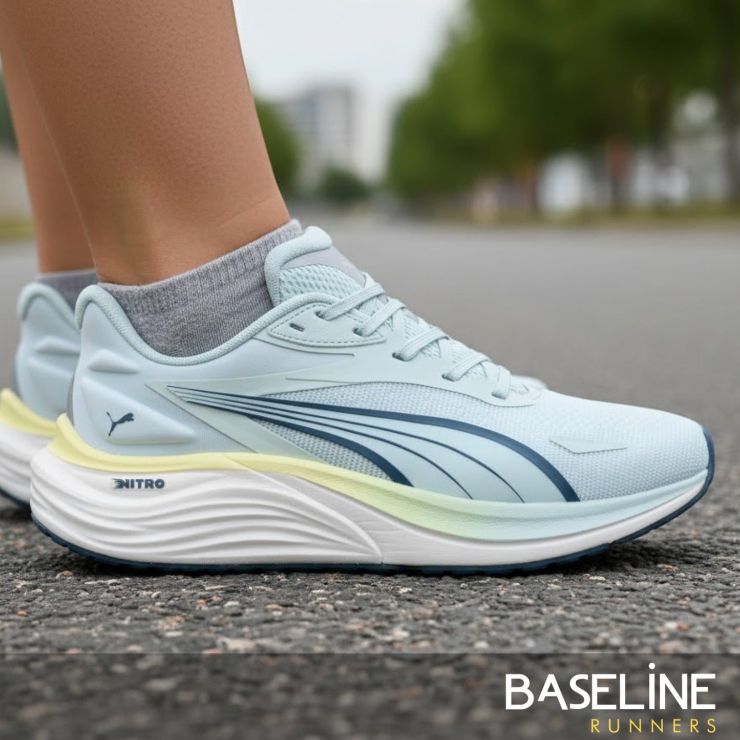 Light blue running shoes with a visible brand logo on a blurred street background