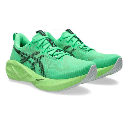 Green Asics running shoes with black accents on a white background