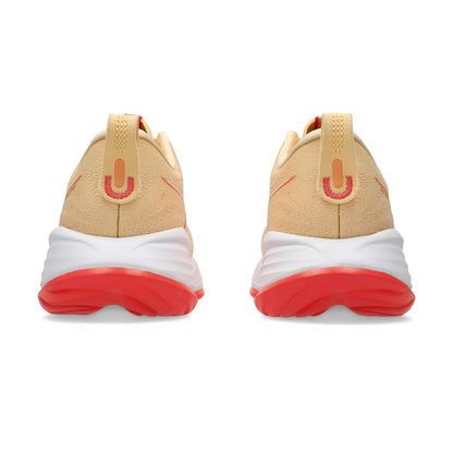 Pair of light orange running shoes on a white background