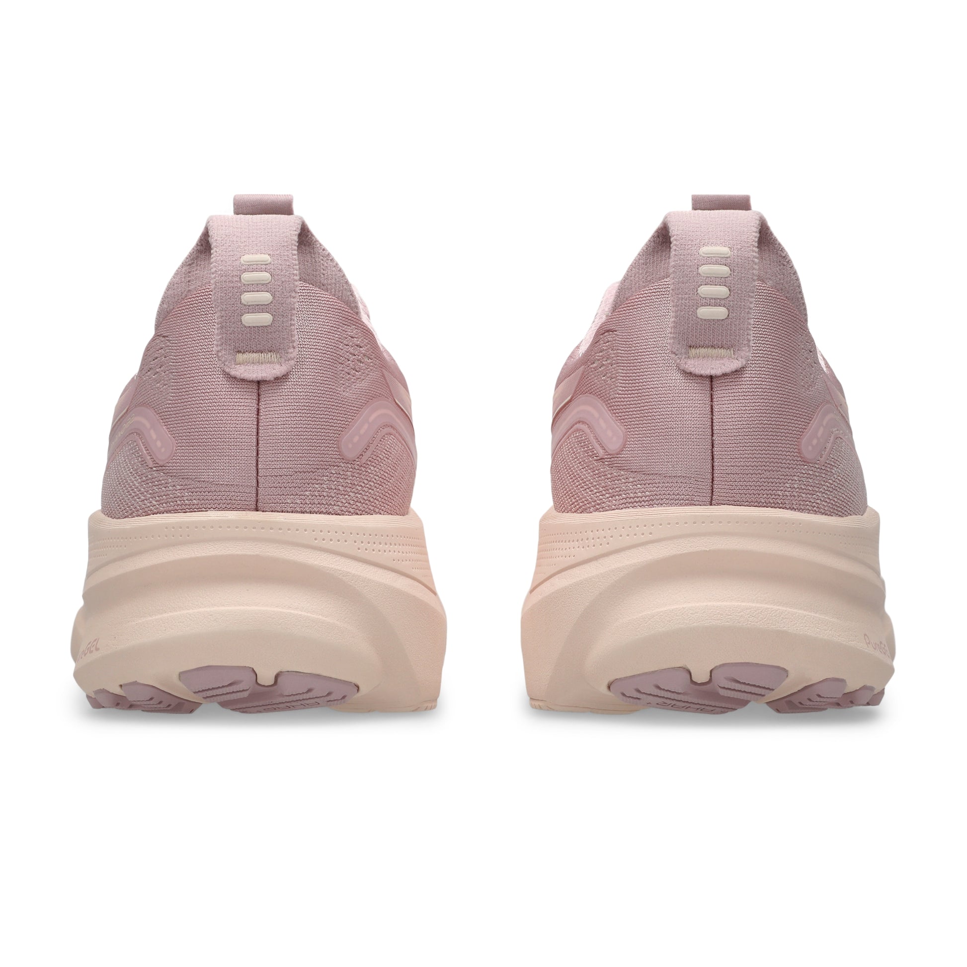 Pink running shoes with a thick sole on a white background