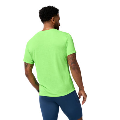 Person wearing a bright green t-shirt and blue shorts on a white background