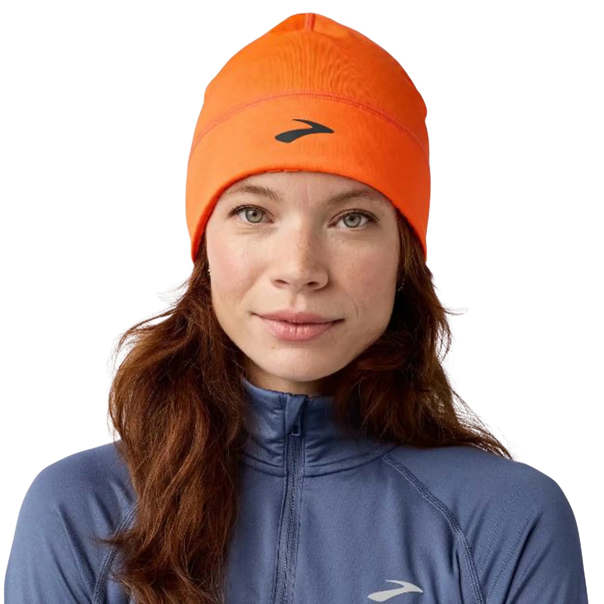 Woman wearing a orange beanie with a black Brooks logo on a white background
