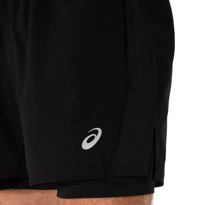 Black athletic shorts with a white logo on a white background
