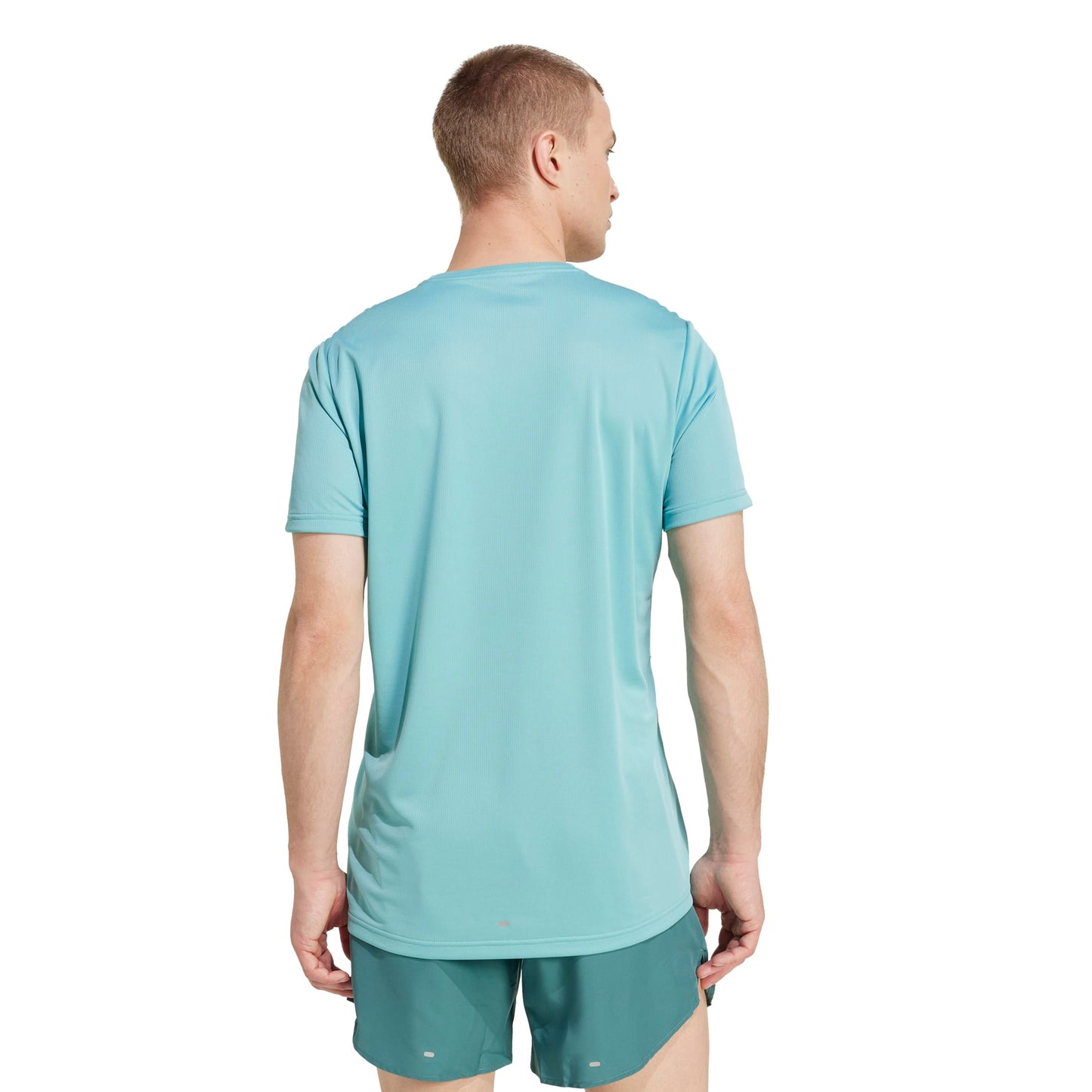A man wearing an Adidas mint shirt