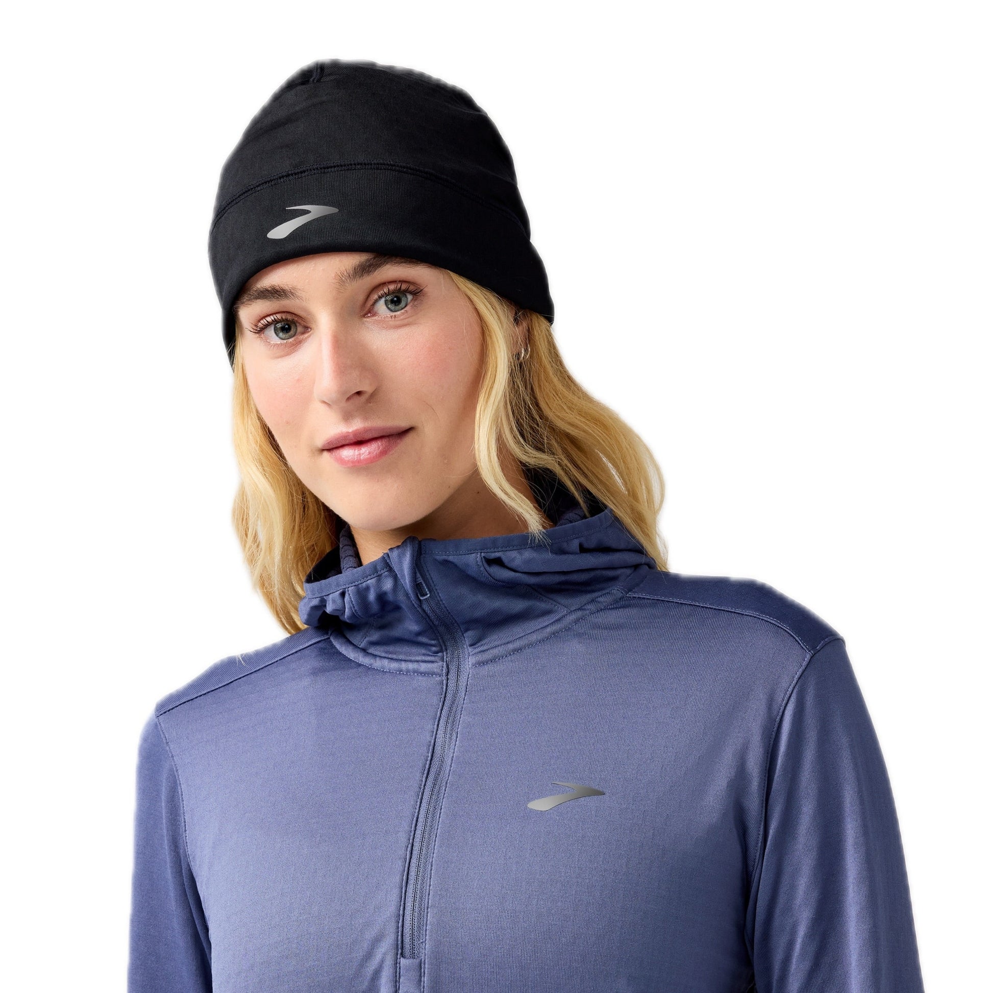 Woman wearing black Brooks beanie on a white background