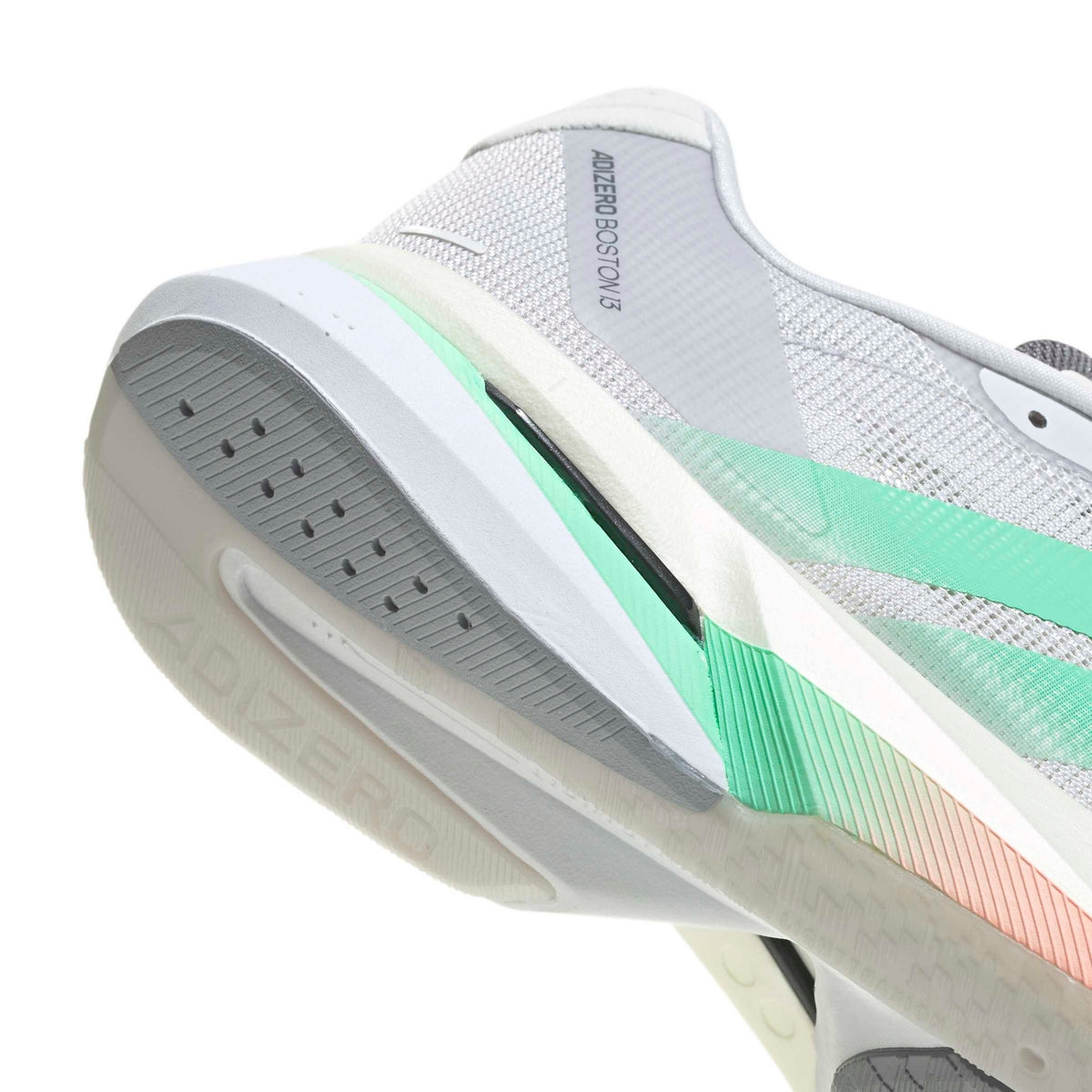 Close-up of a white and gray running shoe showing the midsole, heel area, and a mint green to peach gradient accent stripe, with 'ADIZERO' and 'ADJUSTER 3.0' text visible.