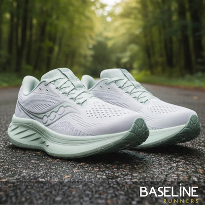 White and light green Saucony running shoe with a light green sole 