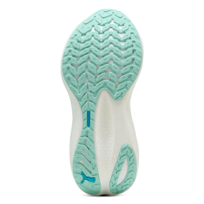 Close-up of a mint green shoe sole with a textured pattern on a white background