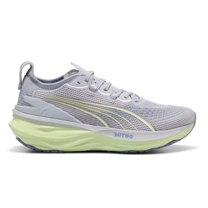 Gray Puma running shoe with green sole on a white background