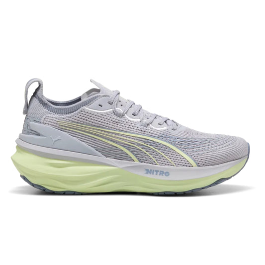 Gray Puma running shoe with green sole on a white background