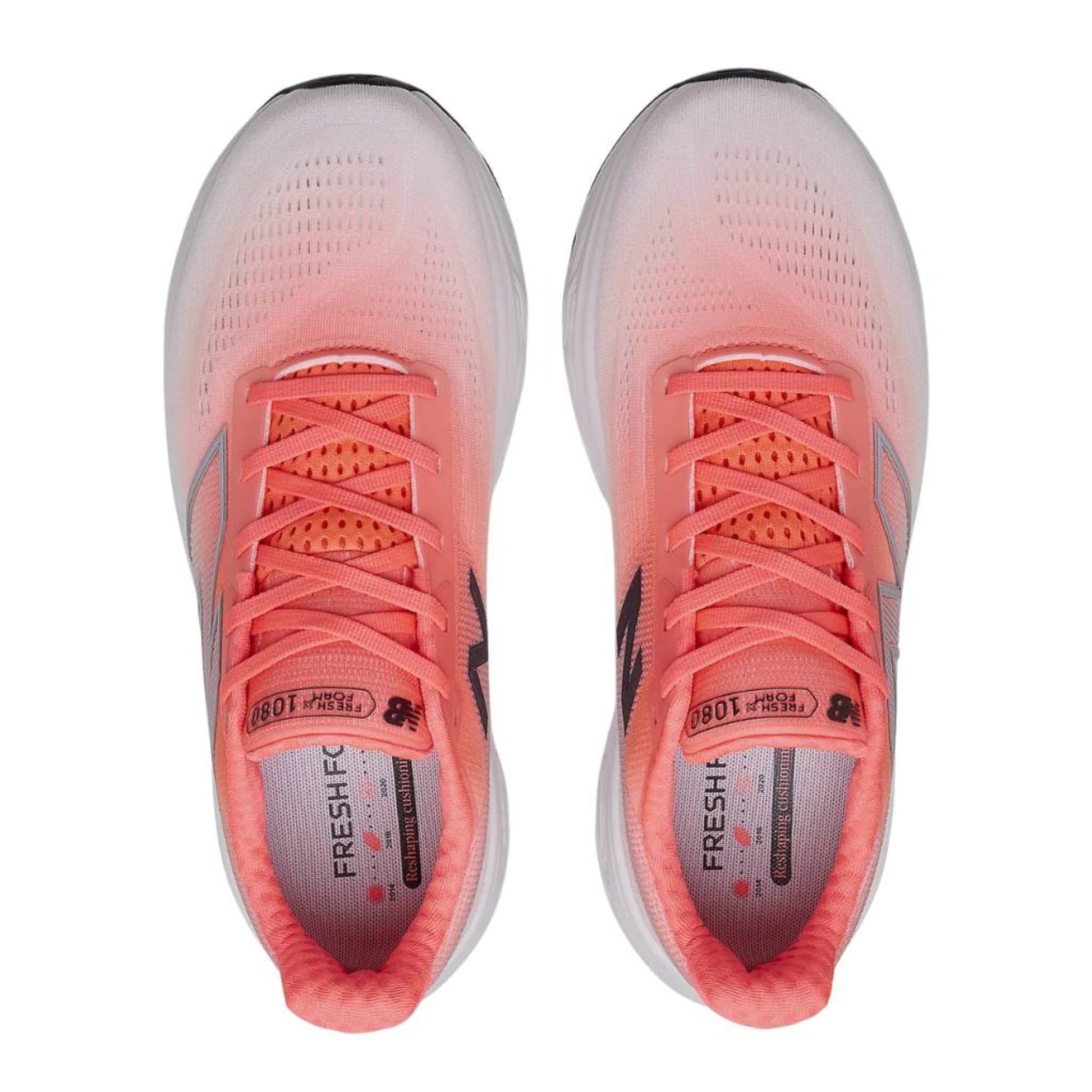 Pair of coral New Balance running shoes with white soles on a white background