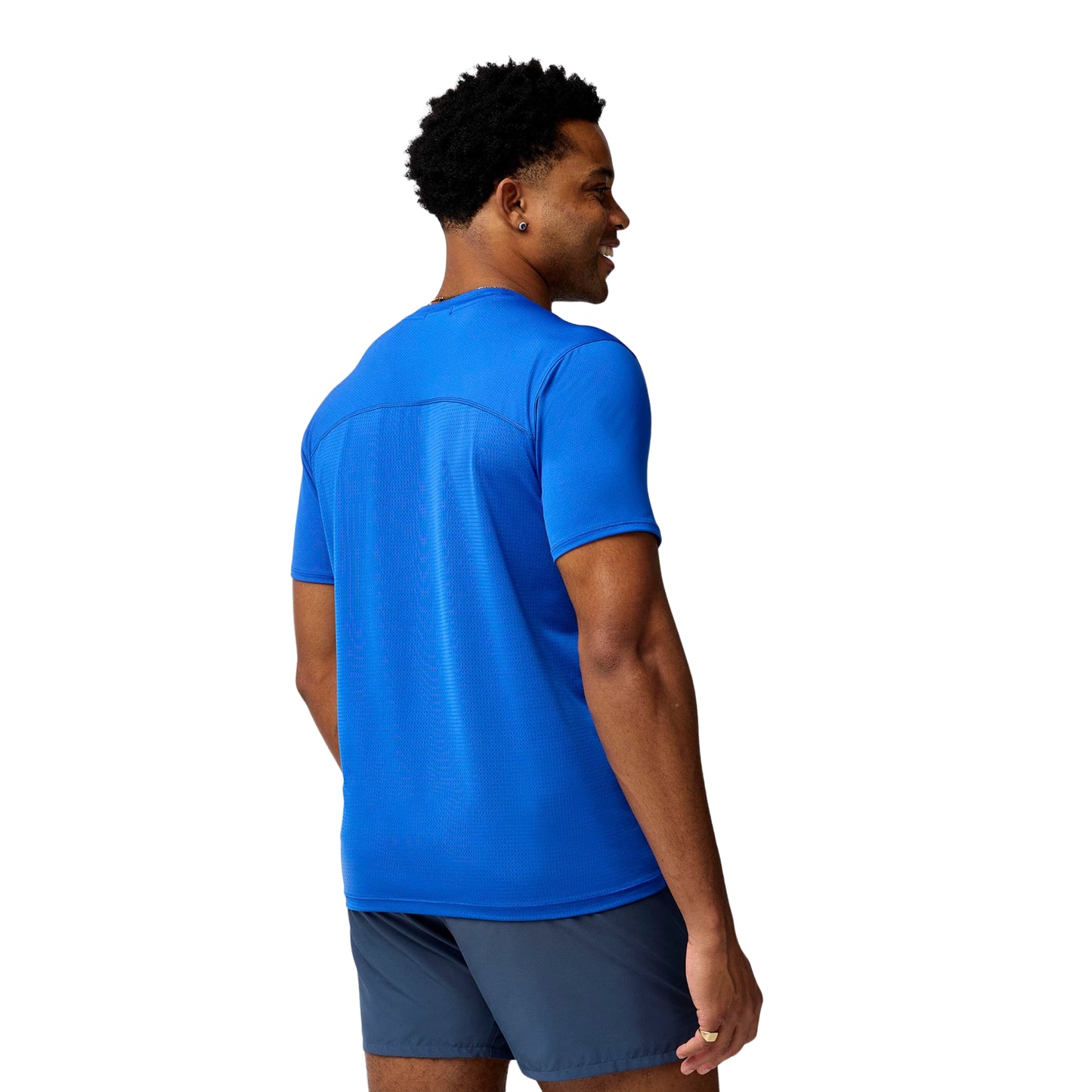 Person wearing a blue t-shirt and shorts on a white background