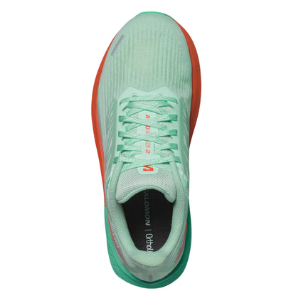 Light green running shoe with orange accents on a white background