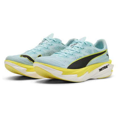 Light blue running shoes with yellow soles on a white background