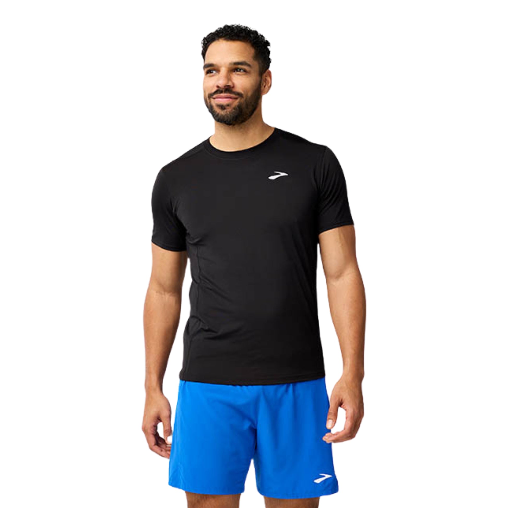 Man wearing a black athletic shirt and blue shorts on a white background
