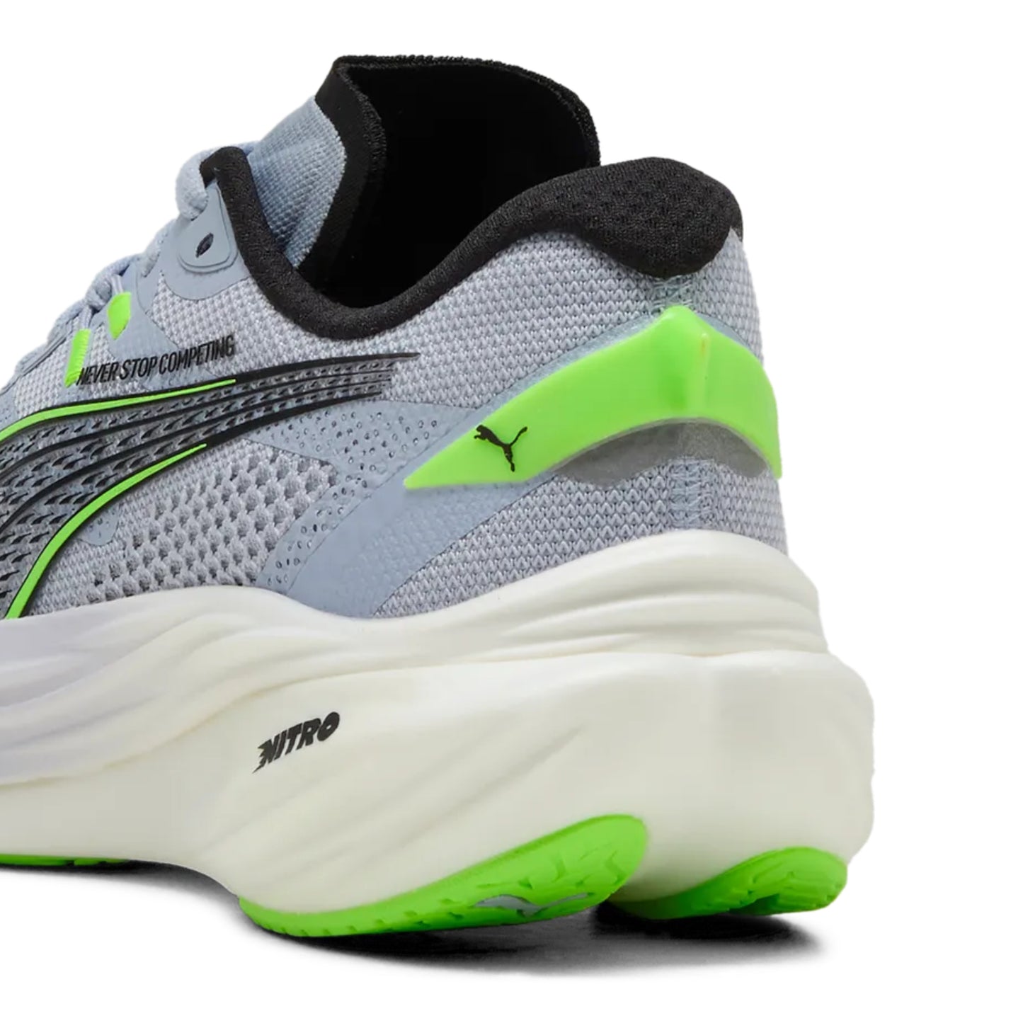 Gray running Puma shoe with green accents on a white background