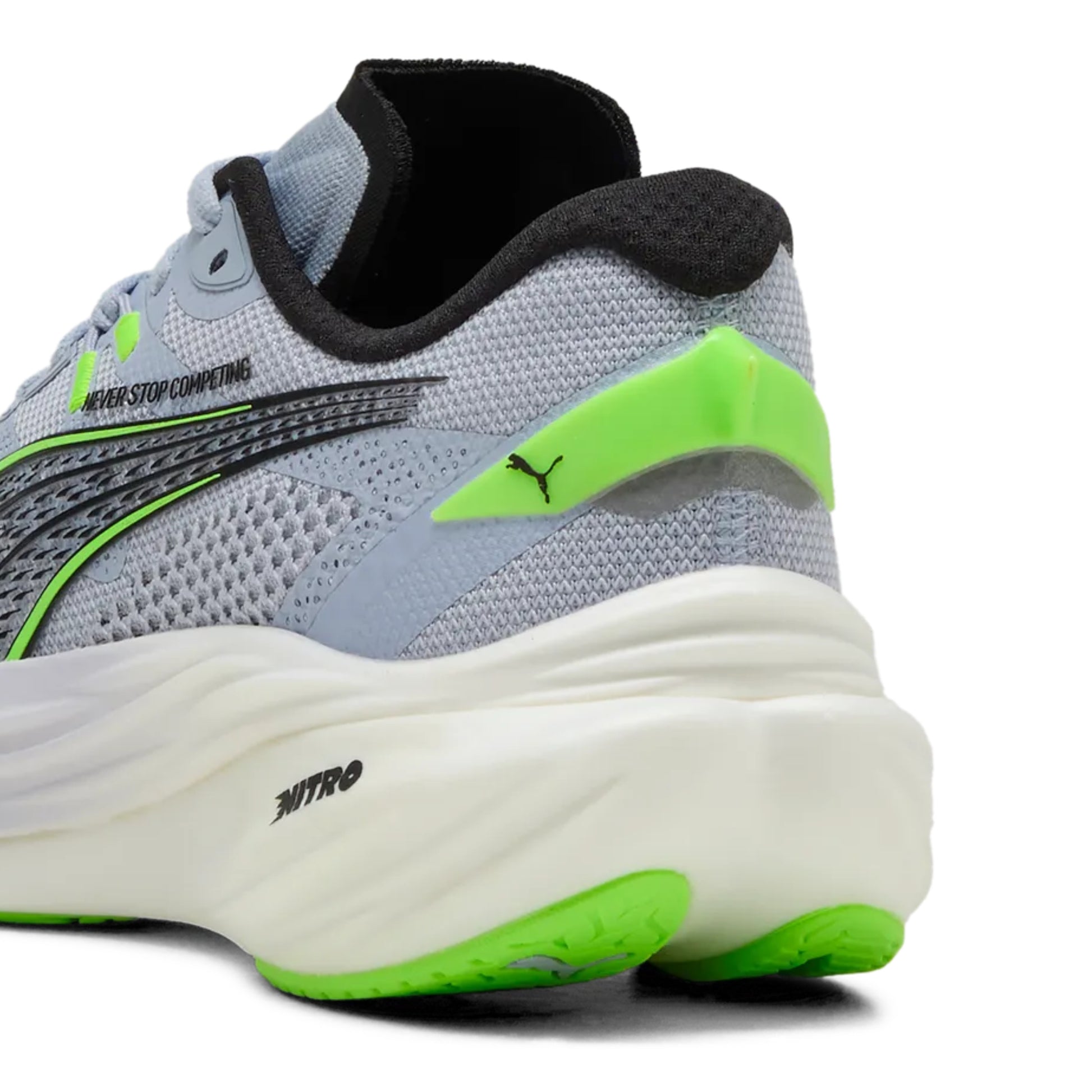 Gray running Puma shoe with green accents on a white background