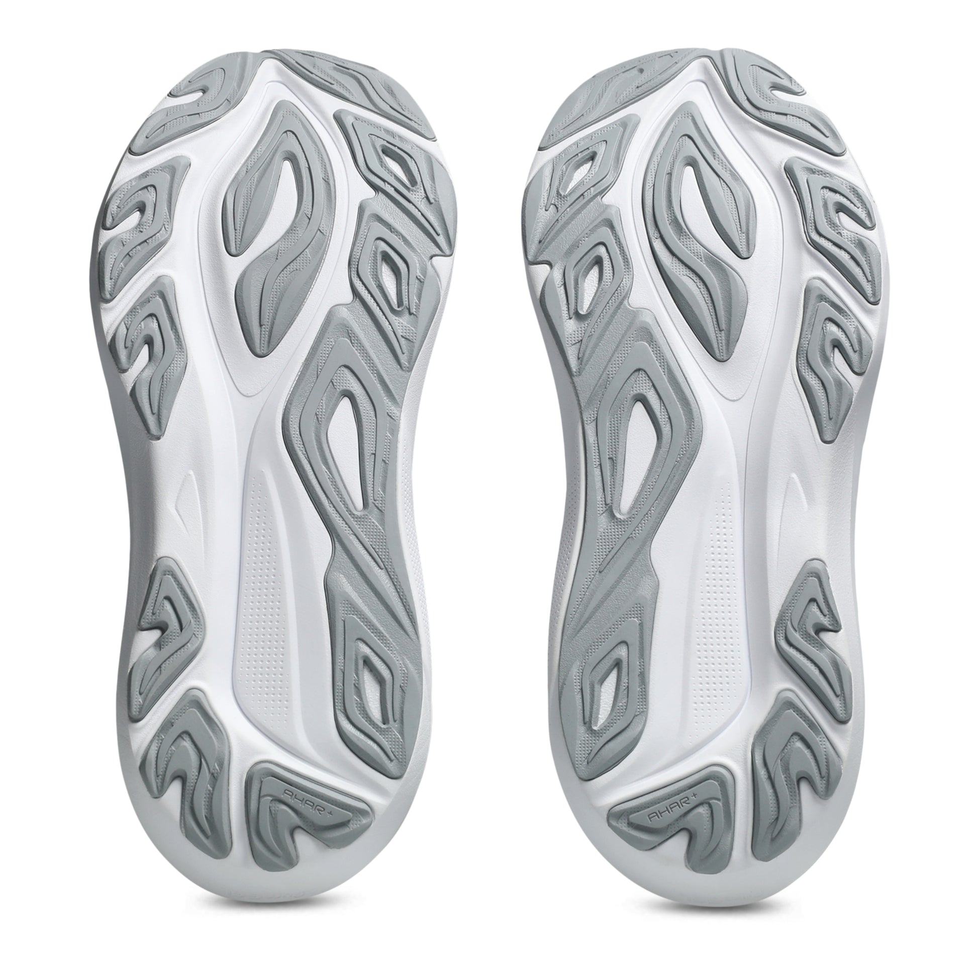 Close-up of white and gray shoe soles with unique tread pattern on a white background