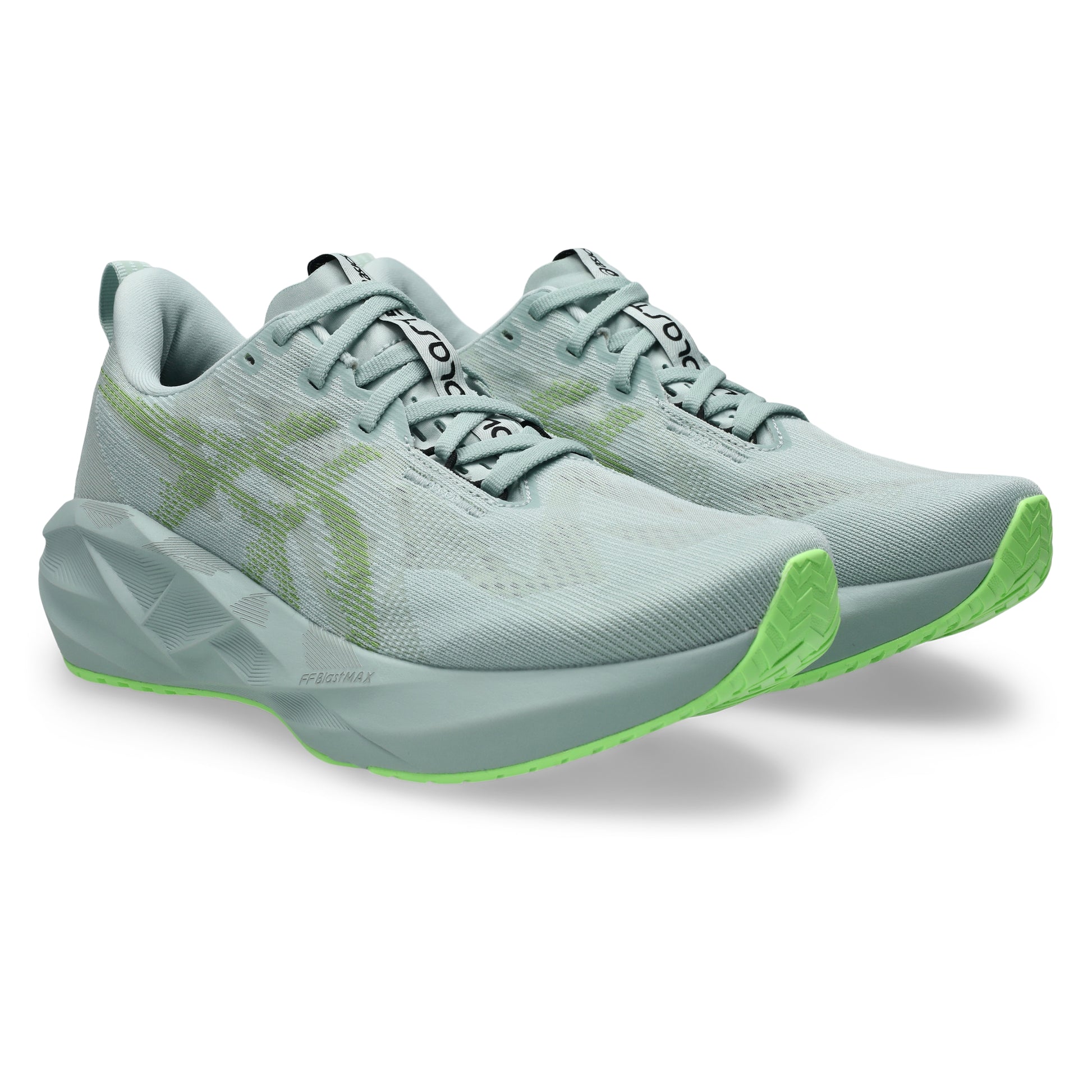Light blue Asics running shoes with green sole on a white background