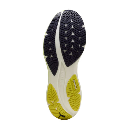 Close-up of a Puma running shoe sole with a white, yellow, and black design on a white background